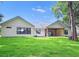 White farmhouse-style home with covered patio and large yard at 19906 Eldorado Dr, Eustis, FL 32736