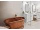 Elegant bathroom with copper tub, double vanity, and modern fixtures at 19906 Eldorado Dr, Eustis, FL 32736