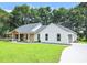 Two-story home with white siding and a stone facade at 19906 Eldorado Dr, Eustis, FL 32736