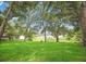 Expansive backyard with mature trees and a lake view at 19906 Eldorado Dr, Eustis, FL 32736