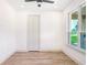 Cozy bedroom with hardwood floors, large window and neutral color palette at 19906 Eldorado Dr, Eustis, FL 32736