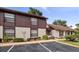 Front view of condo building showcasing parking and landscaping at 225 Terrace Hill Blvd # 1C, Debary, FL 32713