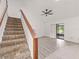 Open living area with gray flooring, stairs and sliding glass doors at 225 Terrace Hill Blvd # 1C, Debary, FL 32713