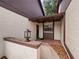 Condo entrance with tiled flooring and exterior light fixture at 225 Terrace Hill Blvd # 1C, Debary, FL 32713