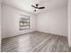 Bright bedroom with gray laminate flooring and ceiling fan at 225 Terrace Hill Blvd # 1C, Debary, FL 32713