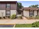 Two-story condo building with brown siding and paved walkway at 225 Terrace Hill Blvd # 1C, Debary, FL 32713