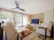 Living room with light walls, beige sofas, and a large TV at 342 Maple Dr, Longwood, FL 32750