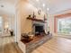Stone fireplace with wood mantle and built-in shelving at 342 Maple Dr, Longwood, FL 32750