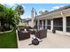 Relaxing patio with wicker furniture and umbrella, ideal for outdoor lounging at 342 Maple Dr, Longwood, FL 32750