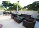Relaxing patio with wicker furniture and umbrella for outdoor enjoyment at 342 Maple Dr, Longwood, FL 32750