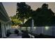 Backyard patio with seating at night, surrounded by a fence and landscaping at 342 Maple Dr, Longwood, FL 32750