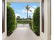 View through entryway to landscaped yard with palm tree at 342 Maple Dr, Longwood, FL 32750