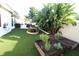 Backyard with artificial turf, raised garden beds, and lush tropical plants at 342 Maple Dr, Longwood, FL 32750