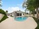 Inviting kidney-shaped pool with a spacious patio and lush landscaping at 342 Maple Dr, Longwood, FL 32750