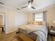 Bedroom with light wood platform bed, ceiling fan, and neutral decor at 342 Maple Dr, Longwood, FL 32750