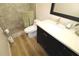 Bathroom with walk-in shower, dark vanity, and quartz countertop at 342 Maple Dr, Longwood, FL 32750