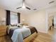 Bright bedroom with light wood floors, ceiling fan, and window coverings at 342 Maple Dr, Longwood, FL 32750