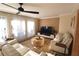 Living room with light walls, beige sofas, and a large TV at 342 Maple Dr, Longwood, FL 32750