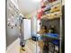 Small kitchen with a refrigerator and several storage shelves at 342 Maple Dr, Longwood, FL 32750