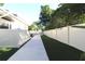 Artificial turf and walkway leading to a fenced backyard at 342 Maple Dr, Longwood, FL 32750