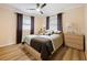 Bedroom with light wood platform bed, ceiling fan, and neutral decor at 342 Maple Dr, Longwood, FL 32750