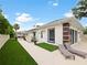 Artificial turf and patio with lounge chairs next to the house and pool at 342 Maple Dr, Longwood, FL 32750
