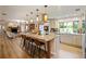 Open concept kitchen with large island and breakfast bar, granite countertops, and hardwood floors at 342 Maple Dr, Longwood, FL 32750