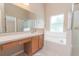 Bathroom with vanity, bathtub, and shower at 1195 Greenley Ave, Groveland, FL 34736