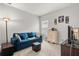 Cozy bedroom with a blue sofa and plenty of natural light at 1282 Zeek Ridge St, Clermont, FL 34715