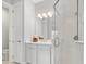 Clean bathroom, featuring a walk-in shower, white vanity, and tiled floors at 1282 Zeek Ridge St, Clermont, FL 34715