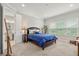 Spacious bedroom with carpeted floor, large window, and ensuite bathroom at 1282 Zeek Ridge St, Clermont, FL 34715
