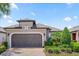 Single-story house with a brown garage door and landscaping at 1282 Zeek Ridge St, Clermont, FL 34715