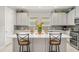 Modern kitchen with white cabinets, stainless steel appliances, and an island at 1282 Zeek Ridge St, Clermont, FL 34715