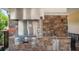 Outdoor kitchen with stainless steel grill and sink at 1282 Zeek Ridge St, Clermont, FL 34715