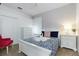 Bright bedroom with a queen-size bed, white dresser, and closet at 4036 Oakrise Loop, Davenport, FL 33837