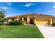 House exterior featuring a two-car garage and well-maintained lawn at 4036 Oakrise Loop, Davenport, FL 33837