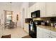 Well-equipped kitchen with granite countertops and black appliances at 4036 Oakrise Loop, Davenport, FL 33837