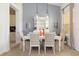 Dining room with white table and chairs, kitchen view at 4036 Oakrise Loop, Davenport, FL 33837