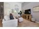 Spacious living room with sectional sofa and large TV at 4036 Oakrise Loop, Davenport, FL 33837