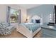 Cozy bedroom with a queen-size bed, armchair, and plenty of natural light at 4036 Oakrise Loop, Davenport, FL 33837