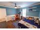 Bright bedroom with blue walls and wood floors at 1134 Harbor Hill St, Winter Garden, FL 34787