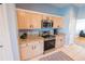 Well-equipped kitchen with stainless steel appliances and light wood cabinets at 1134 Harbor Hill St, Winter Garden, FL 34787