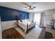Charming bedroom with dark blue accent wall and hardwood floors at 1134 Harbor Hill St, Winter Garden, FL 34787