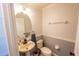 Clean and updated half bathroom with pedestal sink and oval mirror at 1134 Harbor Hill St, Winter Garden, FL 34787