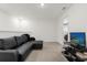 Spacious bonus room with black leather sectional sofa and TV at 3387 Beaute Dr, Kissimmee, FL 34746