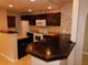 Kitchen with dark wood cabinets and breakfast bar at 200 Afton Sq # 102, Altamonte Springs, FL 32714
