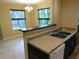 Kitchen features a breakfast bar, double sink, and view into the dining area at 200 Afton Sq # 102, Altamonte Springs, FL 32714