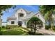 Two story house with white exterior, grey tile roof and landscaping at 8629 Saint Marino Blvd, Orlando, FL 32836