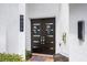 Modern dark brown double front doors with sleek hardware and landscaping at 8629 Saint Marino Blvd, Orlando, FL 32836