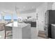 Modern kitchen with white and gray cabinets, a large island, and stainless steel appliances at 8629 Saint Marino Blvd, Orlando, FL 32836